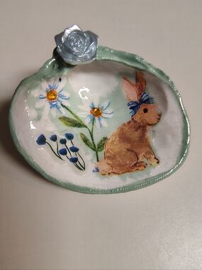 Decoupaged and resined bunny clam shell with embellishments trinket holder.